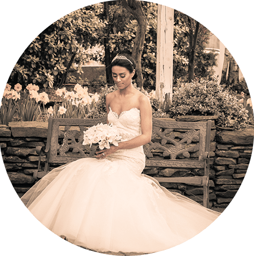 bride in garden sitting on a bench